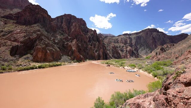 rafters set out from Phantom Ranch area of Colorado River in the Grand Canyon drifting downstream on the muddy river