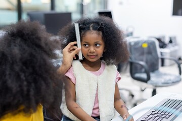 Little girl getting her head measured at school