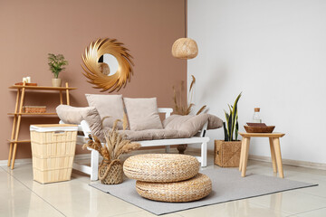 Fototapeta premium Interior of stylish living room with comfortable sofa and poufs