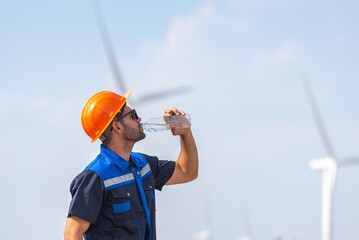 Male man engineer inspection posing check control wind power machine in out door wind energy...