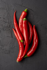 Red and hot Chili pepper on black background