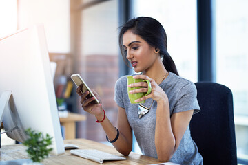 Business, computer and Indian woman with phone in office for coffee break, scroll or social media...