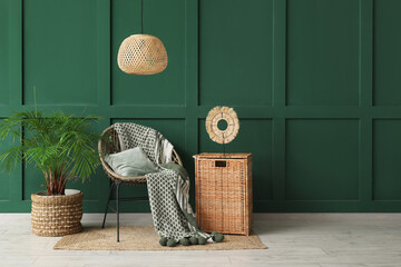 Beautiful interior of living room with armchair, houseplant and wicker box