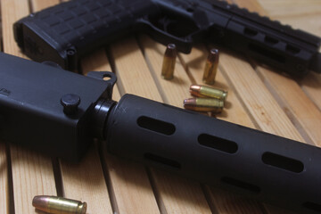 Semi Automatic Handgun on Wooden Table With Ammo