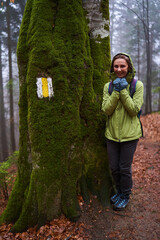 Woman hiker on a rainy day in the forest - 800985165