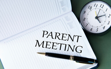PARENT MEETING - words in a white notebook on a dark green background with a clock