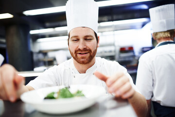 Cooking, chef and man in restaurant kitchen to decorate food plate, fine dining and hospitality...