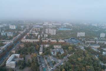 Obraz premium Aerial view of Dnipto city, Ukraine in fog. Cityscape. Panoramic view. Foggy metropolis. Ghost town. Atmospheric shot.