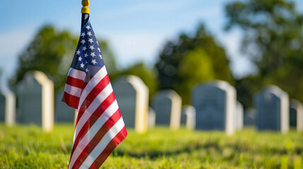 A flag is on a grassy field next to a cemetery