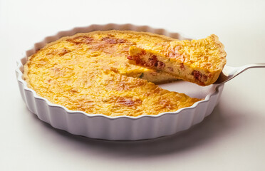 Piece of Quiche Lorraine on white background