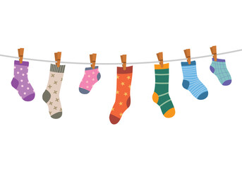 Set of children socks handing on the rope clothesline with clothespins