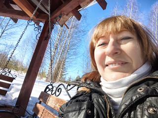 Smiling Woman on the swing on a Sunny Spring, Winter or early autumn Day Outdoors on nature