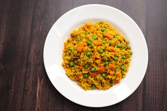 Carrots and Peas Pilaf or Gajar Matar Pulao. It is a one pot rice dish made with Basmati Rice and Vegetables, seasoned with spices, Served with yogurt raita or curd. Healthy weight loss meal. copy