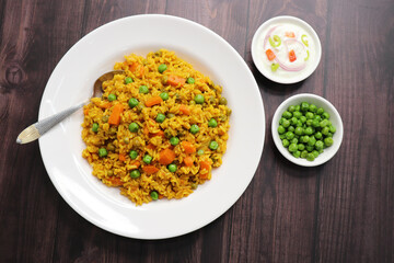 Carrots and Peas Pilaf or Gajar Matar Pulao. It is a one pot rice dish made with Basmati Rice and Vegetables, seasoned with spices, Served with yogurt raita or curd. Healthy weight loss meal. copy