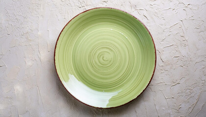 Empty round green plate on light textured stone background. Ceramic tableware. Top view - Powered by Adobe