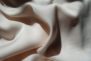 Draped simple unprinted light beige rayon fabric