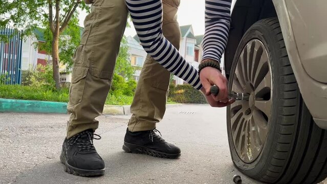 Man changing the wheel of a car