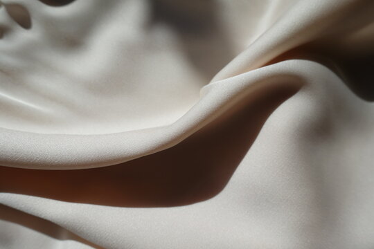 Soft fold on simple light beige rayon fabric