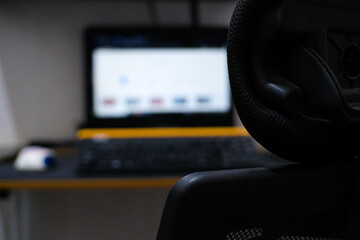 Abstract defocused blurred background of Laptop and gaming chair. Technology. Textured background