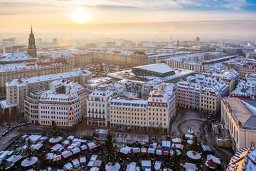The aerial cityscape of Christmas markets in Dresden covered in snow on a cold winter day in late...