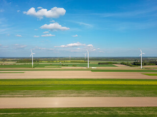 Spring farmlands and electric windmills.