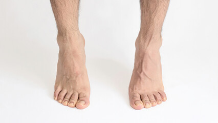 Adult man foot viewed from the inner ankle, standing on tiptoe, left foot with space for text, white background, full foot