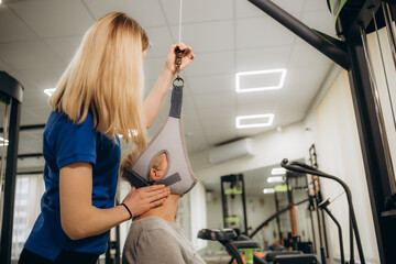 Senior woman workout in rehabilitation center. Personal trainer helping senior woman