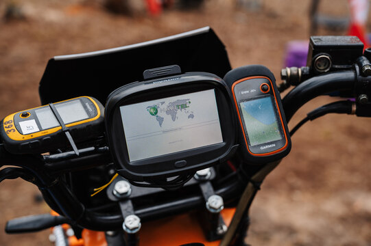 REPUBLIC OF KARELIA, RUSSIA - CIRCA JUNE, 2022: Off-road tournament Ladoga Trophy 2022 in Karelia. Navigator is mounted on the steering wheel of a sports motorcycle for orientation on the map