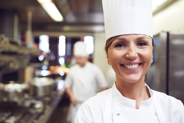 Smile, portrait and woman chef in kitchen for cooking meal, supper or dinner with gourmet cuisine....