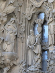 Statues with a biblical, religious scene, made of gray granite, seen at the entrance of the Sagrada Familia church, in Barcelona, Spain
