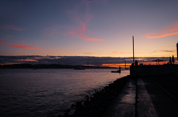 Sunset on Tagus river in Lisbon. View on Bridge