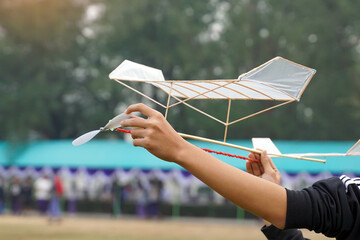 Rubber band powered airplane flies by using the release torque of the rubber to turn the propeller....