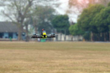 Asian high school students demonstrate flying drones or multirotor unmanned aerial vehicle...
