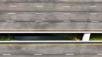 Aerial drone view : An awe-inspiring intercity motorway, devoid of traffic, emerges in all its...