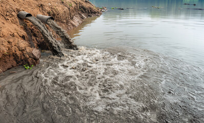 Water pollution in river because industrial not treat water before drain.