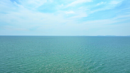 Flying above, revealing the vast expanse of the azure sea under the clear, boundless sky. Azure paradise: Tropical sea's charm. Earth's wonders: Majestic scenery, diverse ecosystems. Drone view.
