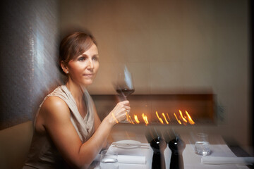 Woman, motion blur and wine glass for dinner, restaurant and table for celebration. Alcohol,...
