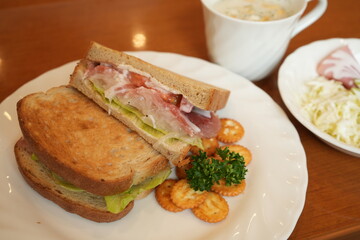 Delicious Prosciutto Ham or Dry-Cured Ham Sandwich made of Toasted Bread, Ham and Lettuce on plate - 生ハム サンドウィッチ 
