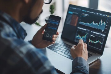 business, technology, internet and people concept - close up of man with laptop computer and smartphone with stock market chart on screen over office background