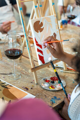 Painting and sip workshop. Woman enjoying art and wine.