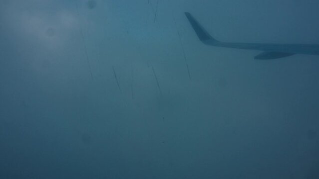 Window view from the airplane flying over Bali island in Indonesia