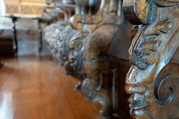 Chapel benches with faces carved in wood. Corpus Christi Convent, Vila Nova de Gaia, Portugal.