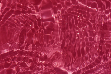 Redwater bubbles on the surface ripple. Defocus blurred transparent red colored clear calm water...