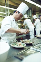 Asian man, chef and plate with food in kitchen for restaurant, service and hospitality in Thailand. Male cook, gourmet meal and nutrition for fine dining, wellness and catering for hotel in Bangkok