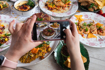Hands of a blogger taking a photo of healthy food to share on social networks