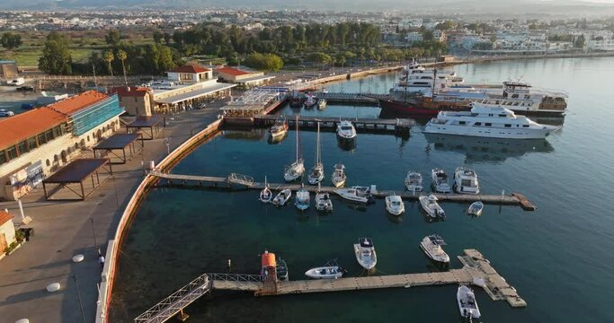 Aerial view of the port and marina in Pathos, Cyprus. Yachts and fishing boats on the mooring of an island in the Mediterranean Sea, cityscape of a sea city. High quality 4k footage
