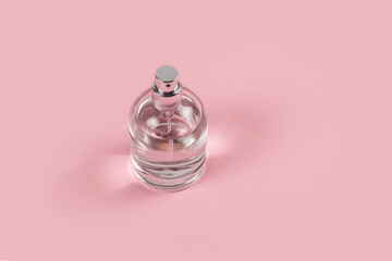 perfume bottle on pink background. copy space for your text