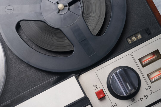 close-up of a black and white music player recorded on magnetic tape of round reels