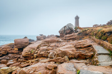 Fototapeta premium Landscape on the Pink Granite Coast in northern Brittany on the municipality of Perros-Guirec, France, with the Ploumanac'h lighthouse, named Mean Ruz and made of the same pink granite.