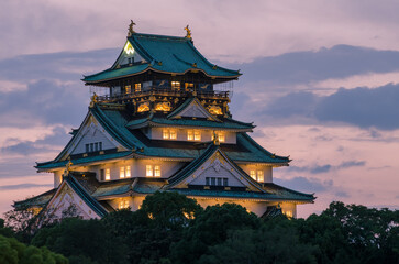 Dusk over Osaka Castle in Japan with its interior lights turned on. This happens just for a few...